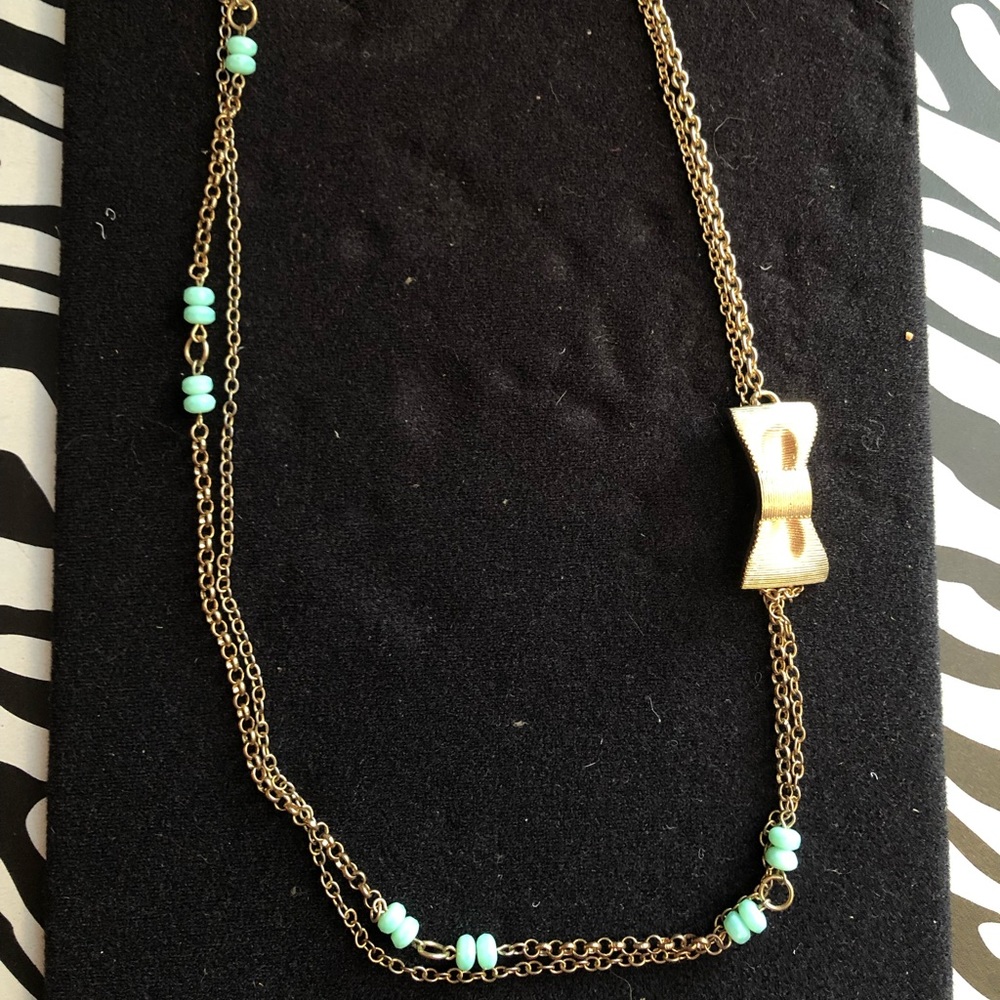 Gold tone necklace with bow and turquoise beads